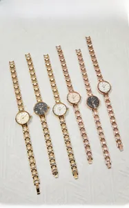 Collection of six elegant women's quartz watches with metal link bracelets on fabric