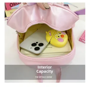 Pink PU leather kids backpack interior view showing storage for phone and accessories