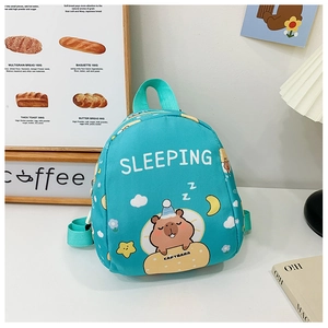 Detail of mint green Capybara kids backpack on a clean white table with warm decor
