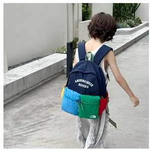 Detail view of large-capacity multi-pocket backpack with colorful patchwork design