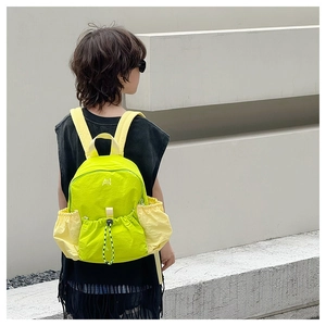 Detail of neon green kids drawstring backpack in lightweight nylon with AN embroidery