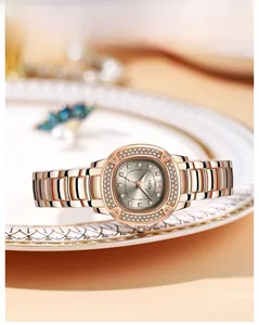 Detail of rose gold watch bezel and dial with sparkling pavé rhinestones in soft lighting