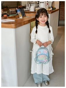Close-up of light blue sequin backpack with butterfly wings and crown detail for kids