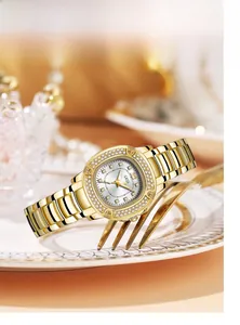 Detail shot of a luxury gold quartz watch with a diamond-encrusted bezel and steel strap