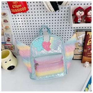 Detail of rainbow glitter wings and heart ornaments on a quilted kids backpack