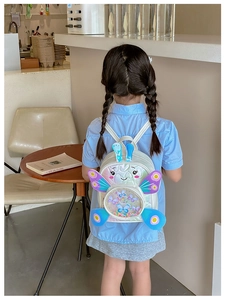 Detail of sequin backpack with holographic butterfly wings and cute rabbit ears