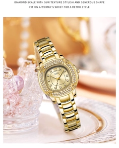Detail of luxury gold steel watch featuring a crystal-set bezel and sunray dial texture