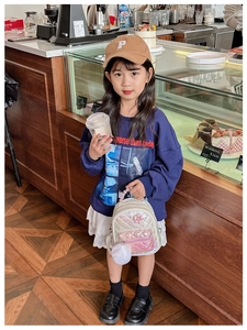 Silver laser texture mini backpack styled with a casual urban kids fashion outfit