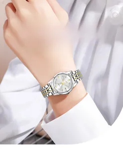 Detail shot of woman wearing a GEDI steel watch with diamond markers and date window