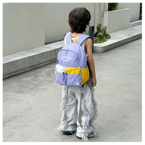 Outdoor view of purple large capacity kids backpack with stylish contrast color pockets