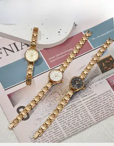 Close-up of vintage alloy quartz wristwatches with gold-plated H-link bracelet bands