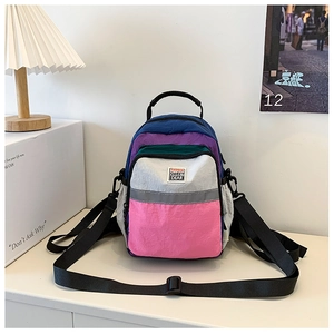 Close-up of a waterproof nylon toddler backpack featuring vibrant color-block panels