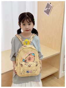 Close-up of kids yellow backpack with cute capybara print and front zipper pocket