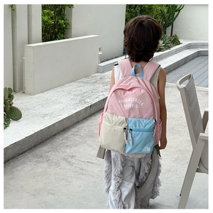 Outdoor back view of child wearing large-capacity color-block school backpack
