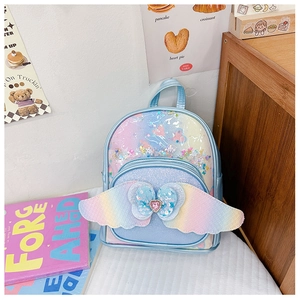 Close-up of sparkling sequin kids backpack with 3D wings and heart gem detail