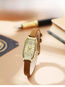Detail of vintage square watch with brown snakeskin texture leather strap and gold case