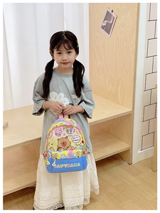 Close-up of colorful cartoon capybara print and zipper pocket on kids school backpack