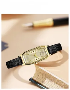 Close-up of retro rectangular GEDI watch with black leather strap on vintage books