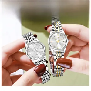 Detail showing two luxury women's steel watches with rhinestone markers and date display