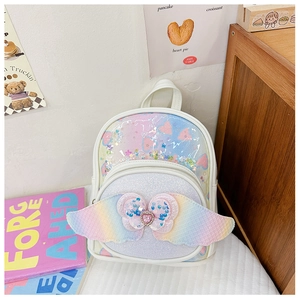 Detail of sequins heart gem and rainbow wings on children mini backpack