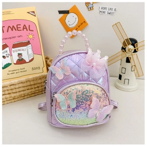 Detail of purple quilted mini backpack with lace crown, sequins and pearl handle