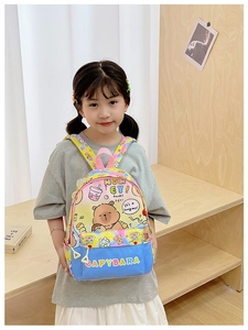 Detail of colorful tie-dye child backpack with cute capybara and cartoon bear print
