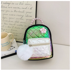 Detailed view of quilted gradient backpack with plush pompom and pink beaded handle