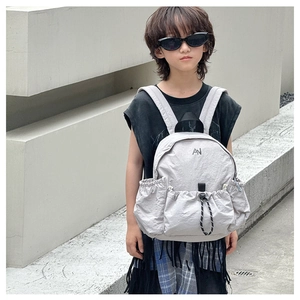 Detail of grey nylon kids backpack with adjustable drawstring and wide shoulder straps