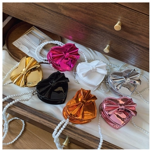 Multiple colors of heart-shaped mini girls bags with bow and pearl chain detail