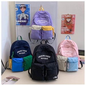 Detailed shot of large capacity school backpacks in four trendy contrasting color combinations