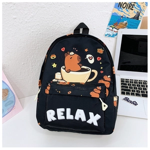 Detail of black cartoon backpack featuring a Capybara in a coffee cup and RELAX text