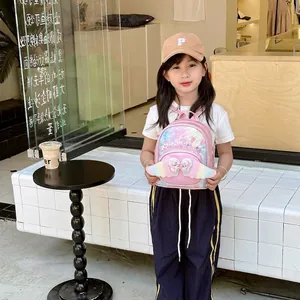 Pink toddler backpack with sequin wings and heart jewel shown on a child model