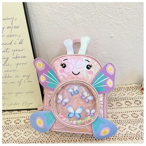 Detail of cute pink holographic kids backpack featuring sequin butterfly and heart quilting
