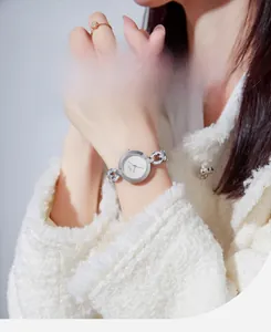 Detailed shot of elegant silver quartz watch with twist chain strap and baton dial markers