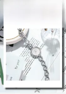 Elegant silver GEDI watch with chain strap and threaded bezel on a minimalist background