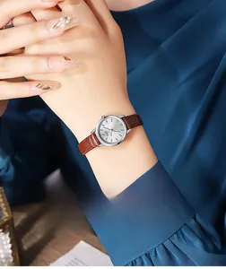 Detailed shot of a vintage GEDI watch with brown leather strap and silver sunray dial
