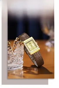 Close-up of GEDI vintage square watch with brown leather strap on crystal crown