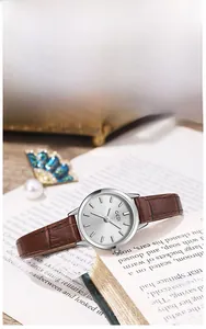 Detailed view of retro small silver dial watch with brown crocodile leather strap