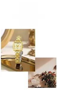 Detailed close-up of square gold watch face featuring a 3D camellia relief and steel band