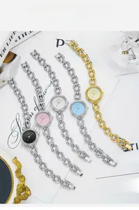 Flat lay of elegant GEDI women quartz watches with oval chain bands in five stylish colors