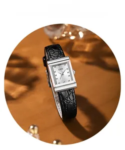 Close-up of vintage rectangular silver watch with black embossed leather strap and Roman numerals