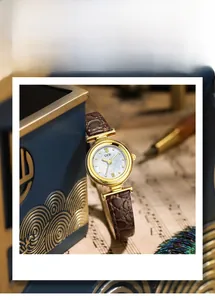 Detail of GEDI quartz watch featuring a pearl dial and brown crocodile pattern leather strap