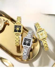 Three elegant square watches in gold and silver with floral motifs on metal trays