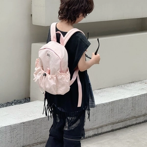 Pink drawstring nylon backpack for children featuring side pockets and a stylish logo