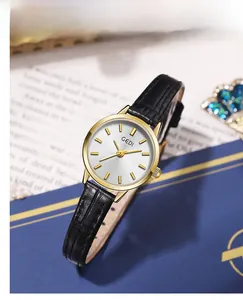 Detailed close-up of a GEDI women watch with black leather strap and gold-toned case dial