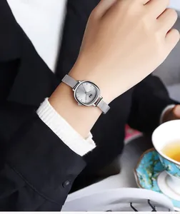 Gedi minimalist silver mesh watch with cushion-shaped sunburst dial on a female wrist