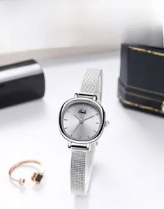 Detail of silver mesh strap watch with sunray square dial and polished finish