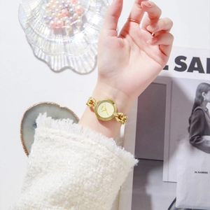 Elegant gold chain bracelet watch for women featuring a vintage round dial and quartz movement