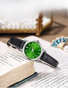 Detail of GEDI women's watch with emerald green sunray dial and black leather strap