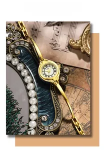 Detail of elegant gold bracelet watch with roman numerals on vintage musical background